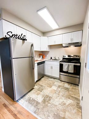 Madison apartment for rent - a renovated kitchen with stainless steel appliances and white cabinets