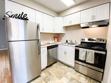 Madison apartment for rent - a kitchen with stainless steel appliances and white cabinets