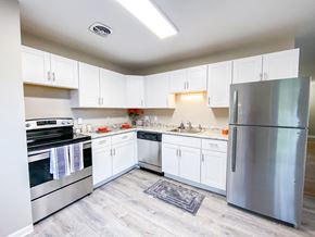 Madison townhouse for rent - an empty kitchen with stainless steel appliances and white cabinets