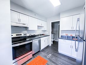 Madison apartment for rent - a white kitchen with stainless steel appliances and white cabinets