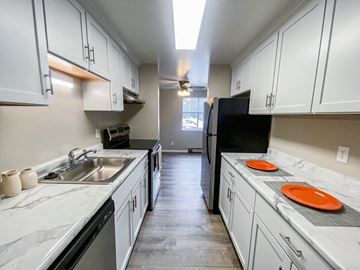 Madison apartment for rent - a kitchen with white cabinets and a sink and a refrigerator