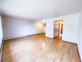 Madison condo for rent - A room with wooden flooring and white walls.