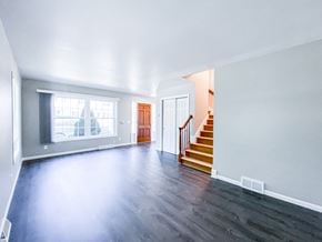Madison apartment for rent - an empty living room with hard wood floors and a staircase