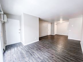 Madison apartment for rent - an empty living room with white walls and wood flooring
