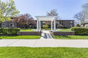 Brookfield apartment for rent - a white gazebo on a sidewalk in front of a brick building