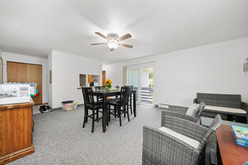 Kenosha apartment for rent - A living room with a dining table and chairs.