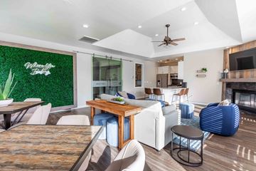 Aurora apartment for rent - A modern living room with a wooden dining table and white chairs.