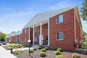 Madison apartment for rent - A red brick building with a white roof and a front porch.