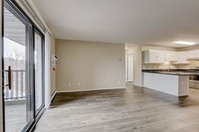 Appleton apartment for rent - an empty living room and kitchen with a sliding glass door