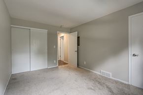 New Berlin apartment for rent - a bedroom with a carpeted floor and a door to a closet