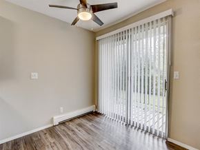 West Bend apartment for rent - a living room with a sliding glass door and a ceiling fan