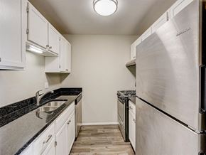 West Bend apartment for rent - a kitchen with white cabinets and a stainless steel refrigerator