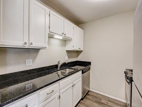 West Bend apartment for rent - a kitchen with white cabinets and a sink
