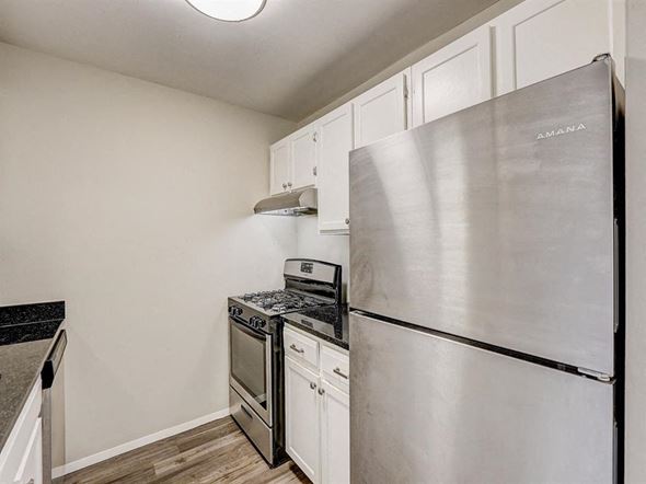 West Bend apartment for rent - a kitchen with stainless steel appliances and white cabinets
