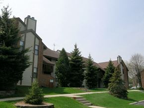 New Berlin apartment for rent - an apartment building with green grass and trees
