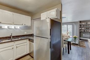 Appleton apartment for rent - a kitchen with white cabinets and a stainless steel refrigerator