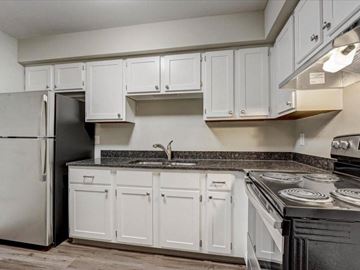 Hartland apartment for rent - a kitchen with white cabinets and a stove and a refrigerator