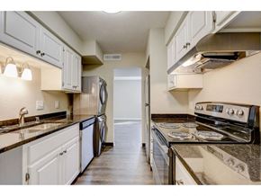 Oconomowoc apartment for rent - a kitchen with white cabinets and stainless steel appliances
