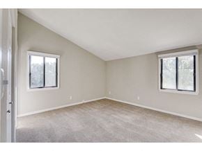 Oconomowoc apartment for rent - an empty bedroom with two windows and carpeting
