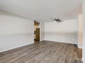 Appleton apartment for rent - an empty living room with wood floors and a ceiling fan