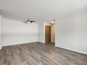 Appleton apartment for rent - an empty living room with wood floors and a ceiling fan