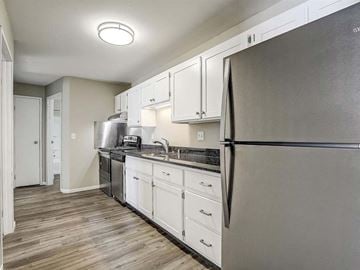 Appleton apartment for rent - a kitchen with stainless steel appliances and white cabinets
