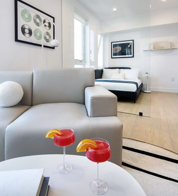 Los Angeles Ca 90028 apartment for rent - Two drinks are on a table in a living room.