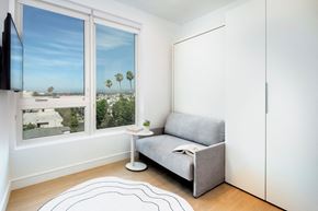 Los Angeles Ca 90028 apartment for rent - A living room with a grey couch and a television.