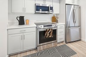 La Mesa apartment for rent - a kitchen with stainless steel appliances and white cabinets