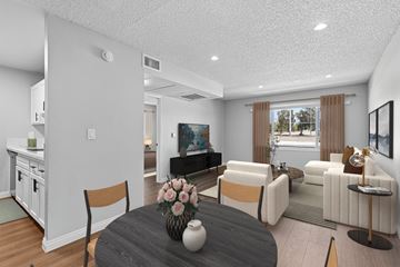 Azusa apartment for rent - A modern living room with a grey table and white chairs.