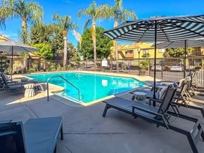 Ontario apartment for rent - swimming pool with chair lounge and umbrella