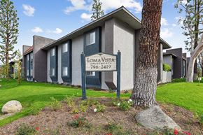 San Bernardino apartment for rent - A building with a sign that says Lomavista in front of it.