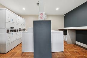 San Bernardino apartment for rent - A kitchen with a black counter and white appliances.