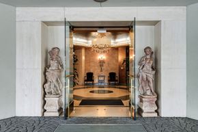 Los Angeles apartment for rent - two statues in the lobby of a building with glass doors