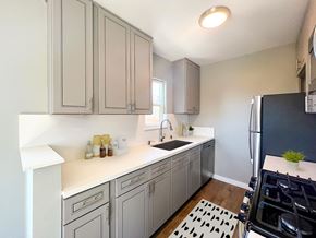 Los Angeles apartment for rent - a kitchen with gray cabinets and a black refrigerator