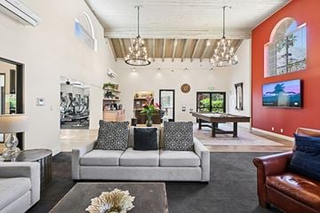 Palm Springs apartment for rent - A living room with a grey couch and a brown leather chair.