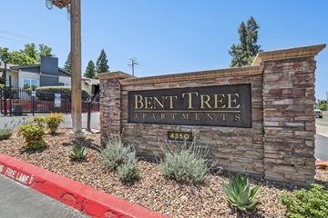 Sacramento apartment for rent - A sign for Bent Tree Apartments is displayed in front of a building.