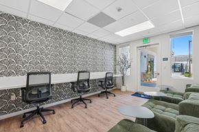 Moreno Valley apartment for rent - Tech lounge at Altitude apartment homes with plush seating and desks.