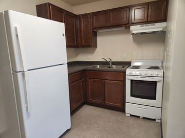 Kokomo apartment for rent - an empty kitchen with a refrigerator and a stove
