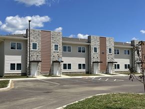 Marion triplex for rent - an apartment building with an empty parking lot