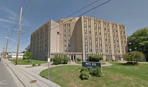 Evansville apartment for rent - a large building with an flag in front of it