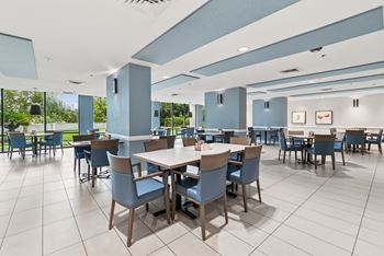 A large dining room with tables and chairs.