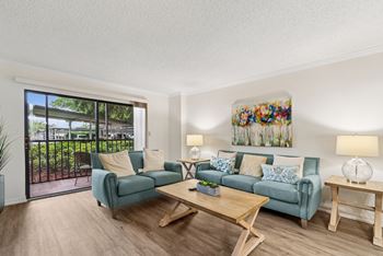 A living room with a blue couch and a wooden coffee table.