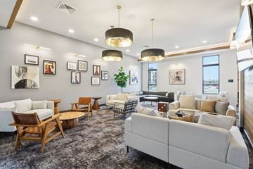Deforest apartment for rent - A spacious living room with a variety of furniture and decorative items.