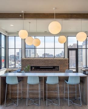 Rochester apartment for rent - a kitchen with a marble counter top and blue chairs