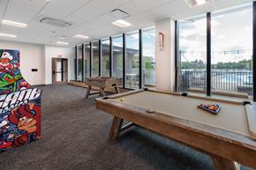 Saint Louis apartment for rent - A billiard table in a room with a pool table poster on the wall. at The Residences at Tesson Ridge Apartments, Missouri