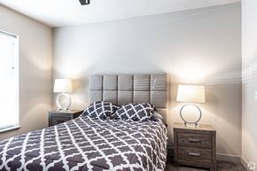 Independence apartment for rent - a bedroom with a bed and two lamps and a window at Trinity Woods Apartments, Independence, MO, 64015