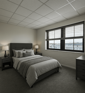 Baltimore apartment for rent - A bedroom with a large bed and a window with blinds.