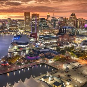 Baltimore apartment for rent - A cityscape at dusk with a large building in the foreground.