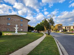 Dundalk apartment for rent - A building with the words "Holland East" on it is surrounded by a grassy area and a sidewalk.